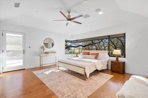 a bedroom with a large bed and a large window