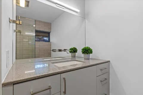 a view of a patio with table and chairs and potted plants