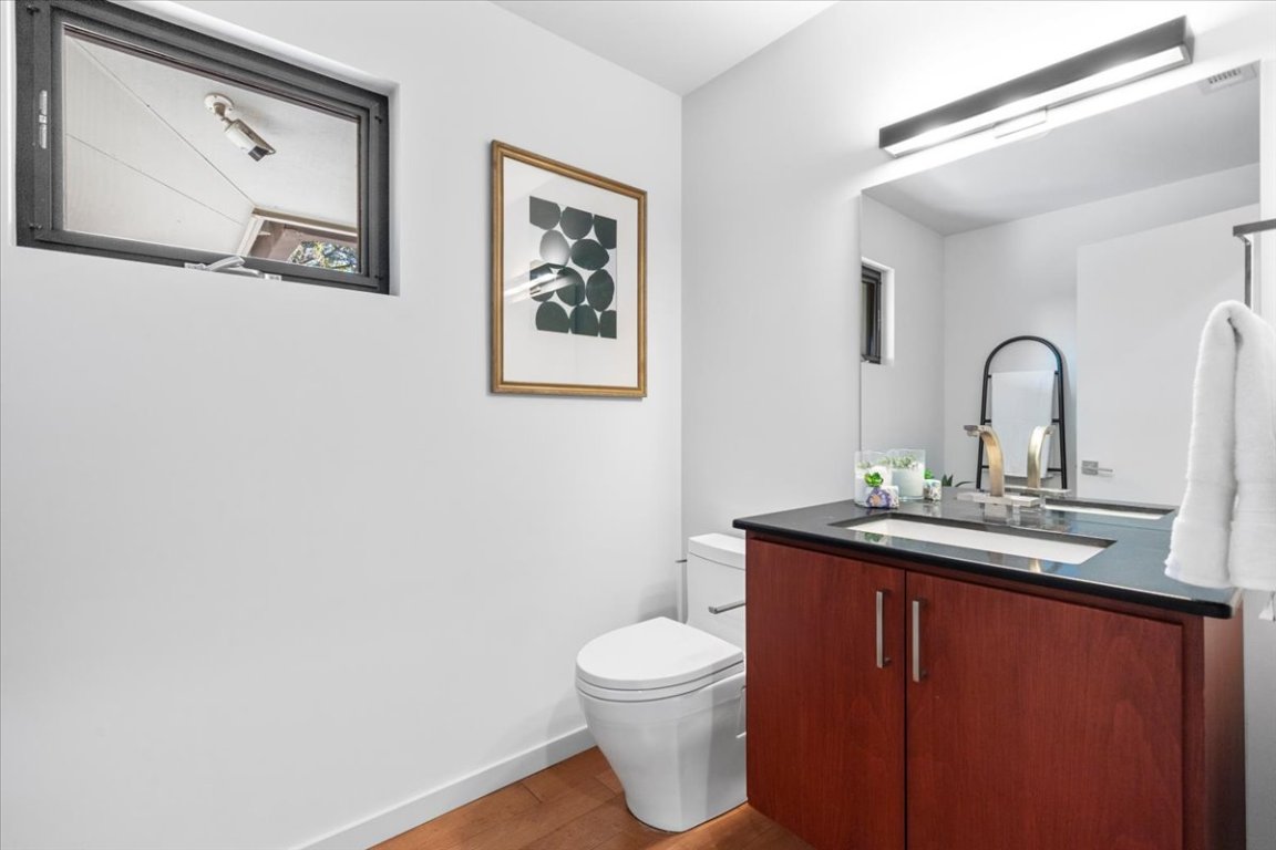 3923 Glengarry Drive Austin, TX 78731 - Photo 25 of 33 a bathroom with a toilet a sink and mirror