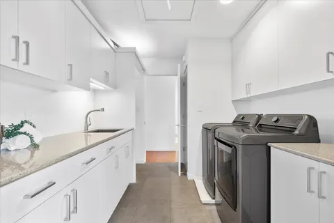 a view of a patio with couches table and chairs and potted plants