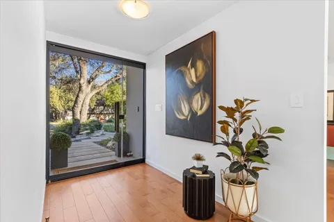 a living room with furniture large window and a flat screen tv