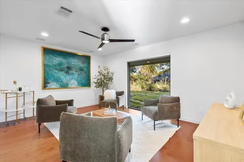 a living room with furniture and large windows