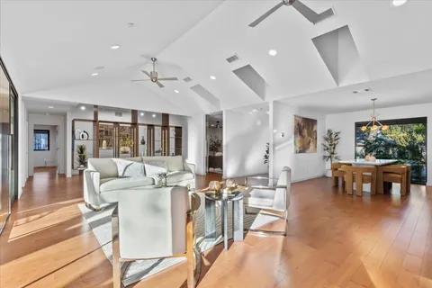 a view of a hallway with wooden floor and furniture