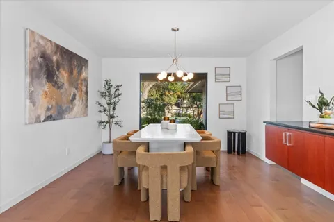 a large kitchen with kitchen island granite countertop a large window and stainless steel appliances