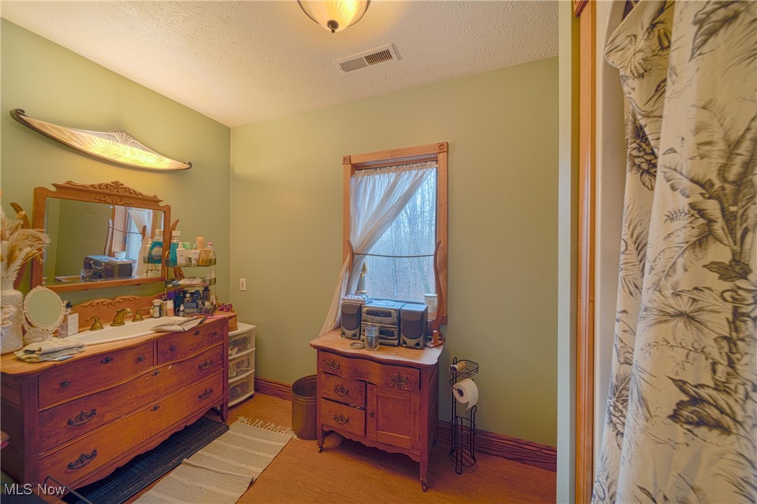 10000 Wisner Road Willoughby, OH 44094 - Photo 25 of 32 Bedroom featuring hardwood / wood-style flooring and a textured ceiling