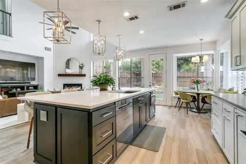 a kitchen with stainless steel appliances granite countertop a stove and cabinets