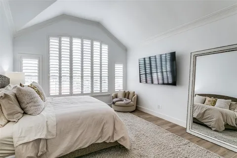 a bedroom with a bed and glass window
