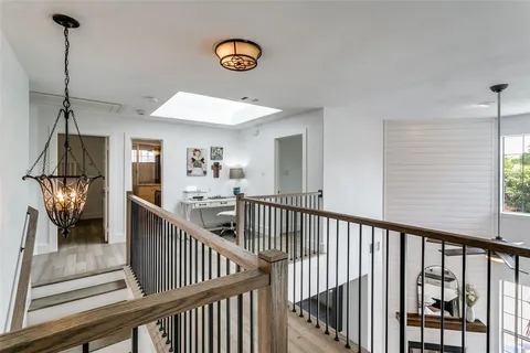 a view of staircase with railing and white walls