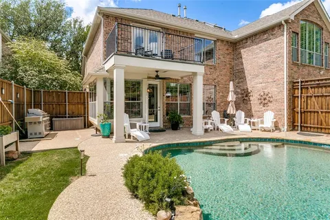 a view of a house with pool and sitting area