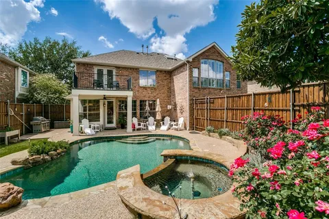 a front view of a house with swimming pool having outdoor seating