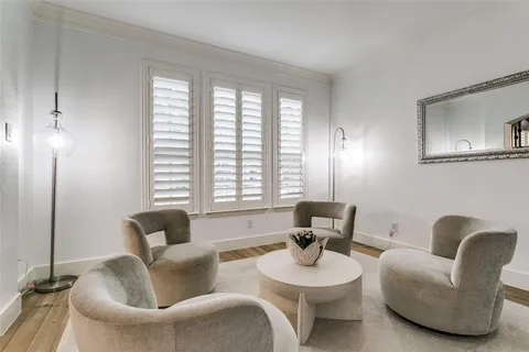 a living room with furniture and two window