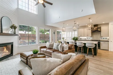 a living room with furniture kitchen view and a fireplace