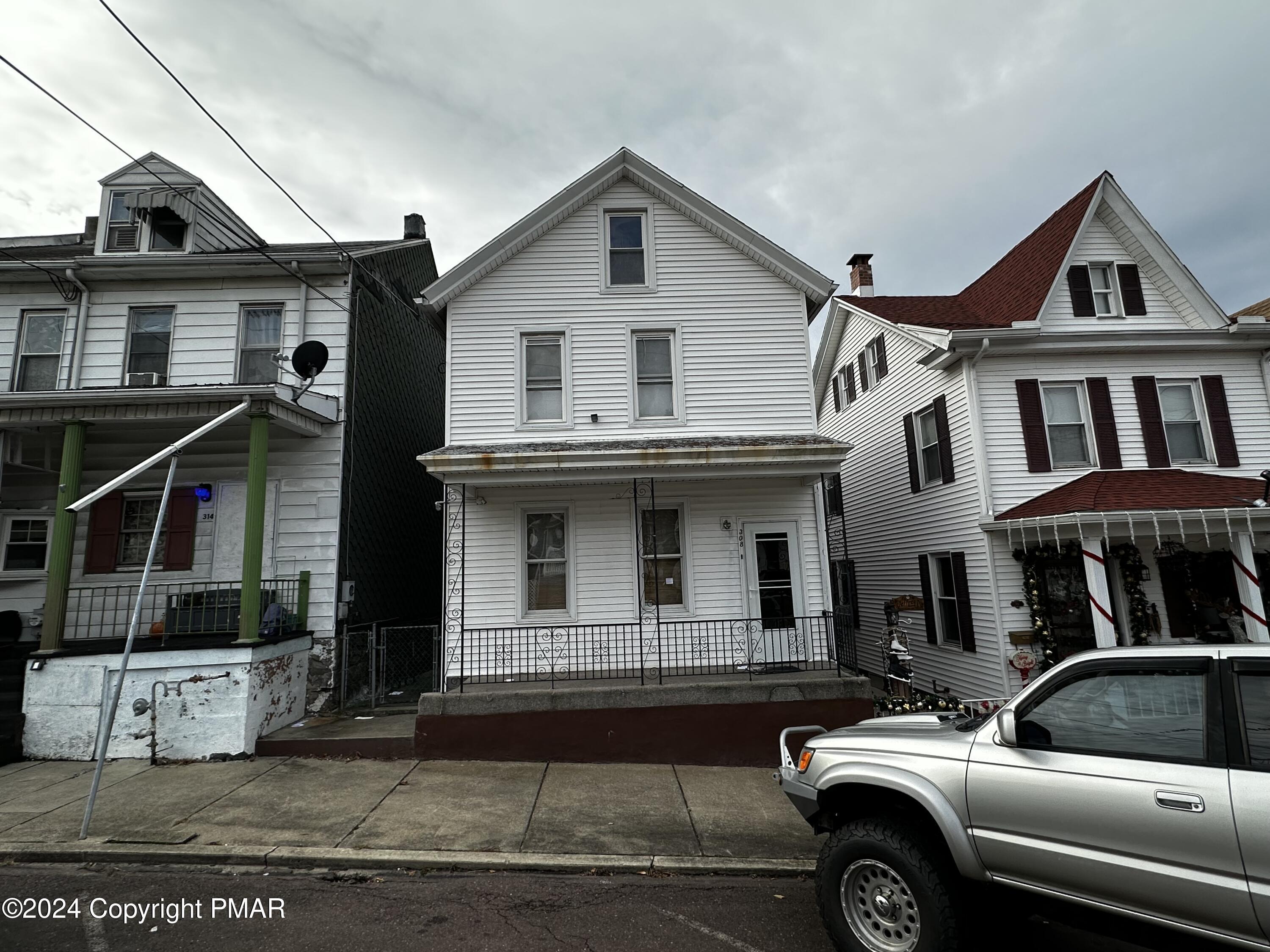 a view of a car parked in front of a house