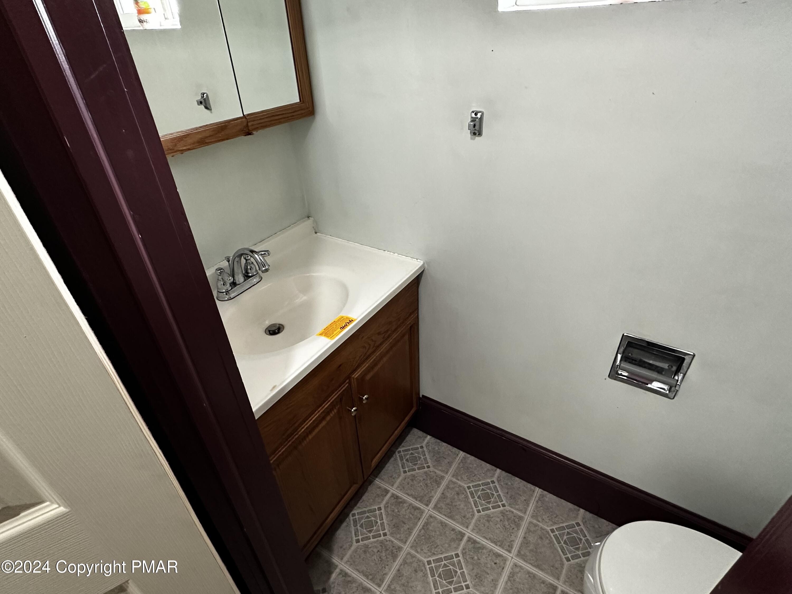 308 South Beech Street Mount Carmel, PA 17851 - Photo 19 of 34 a bathroom with a sink and a mirror