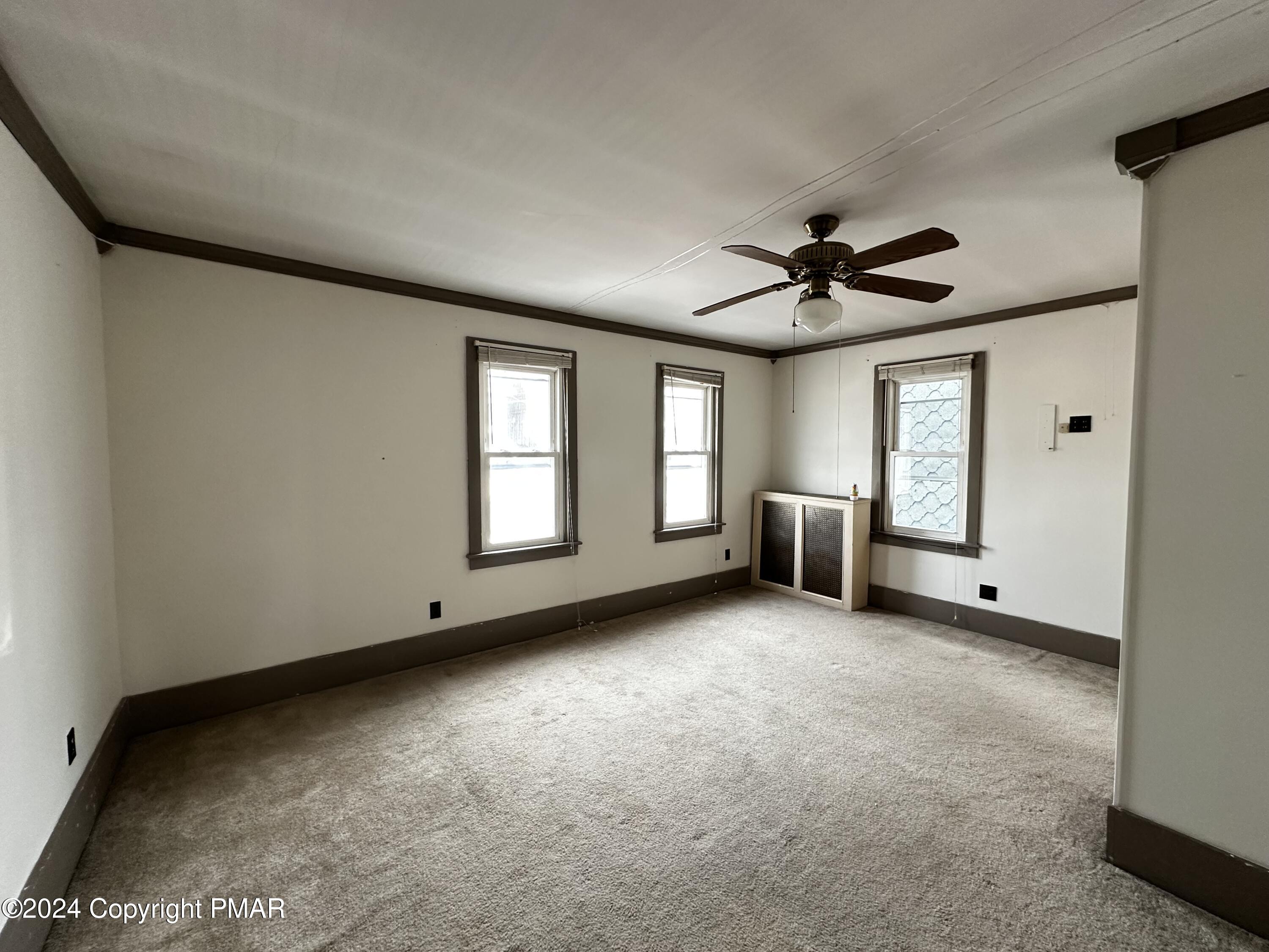 308 South Beech Street Mount Carmel, PA 17851 - Photo 22 of 34 a view of a livingroom with a ceiling fan and window