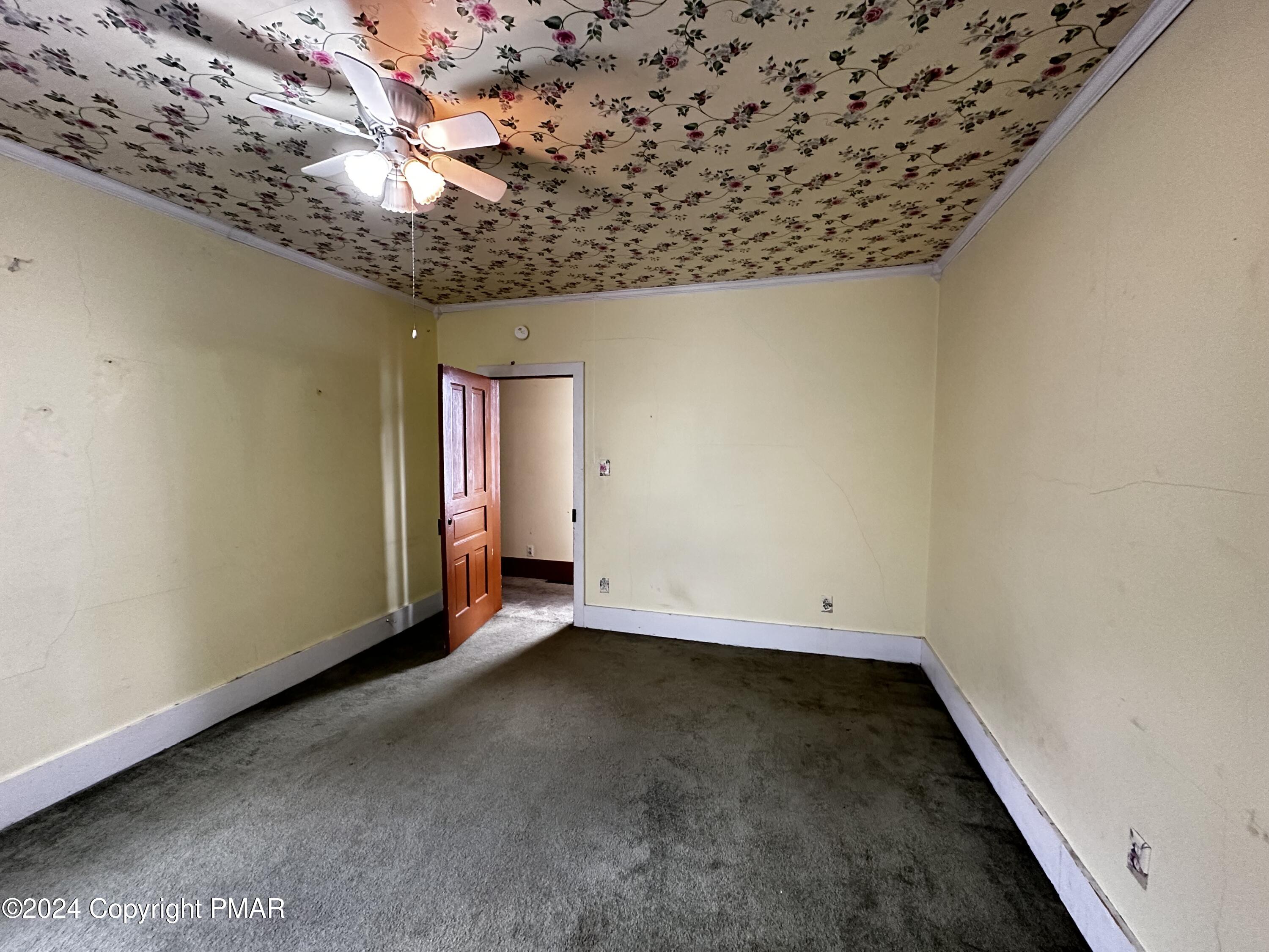 308 South Beech Street Mount Carmel, PA 17851 - Photo 24 of 34 an empty room with a ceiling fan and window