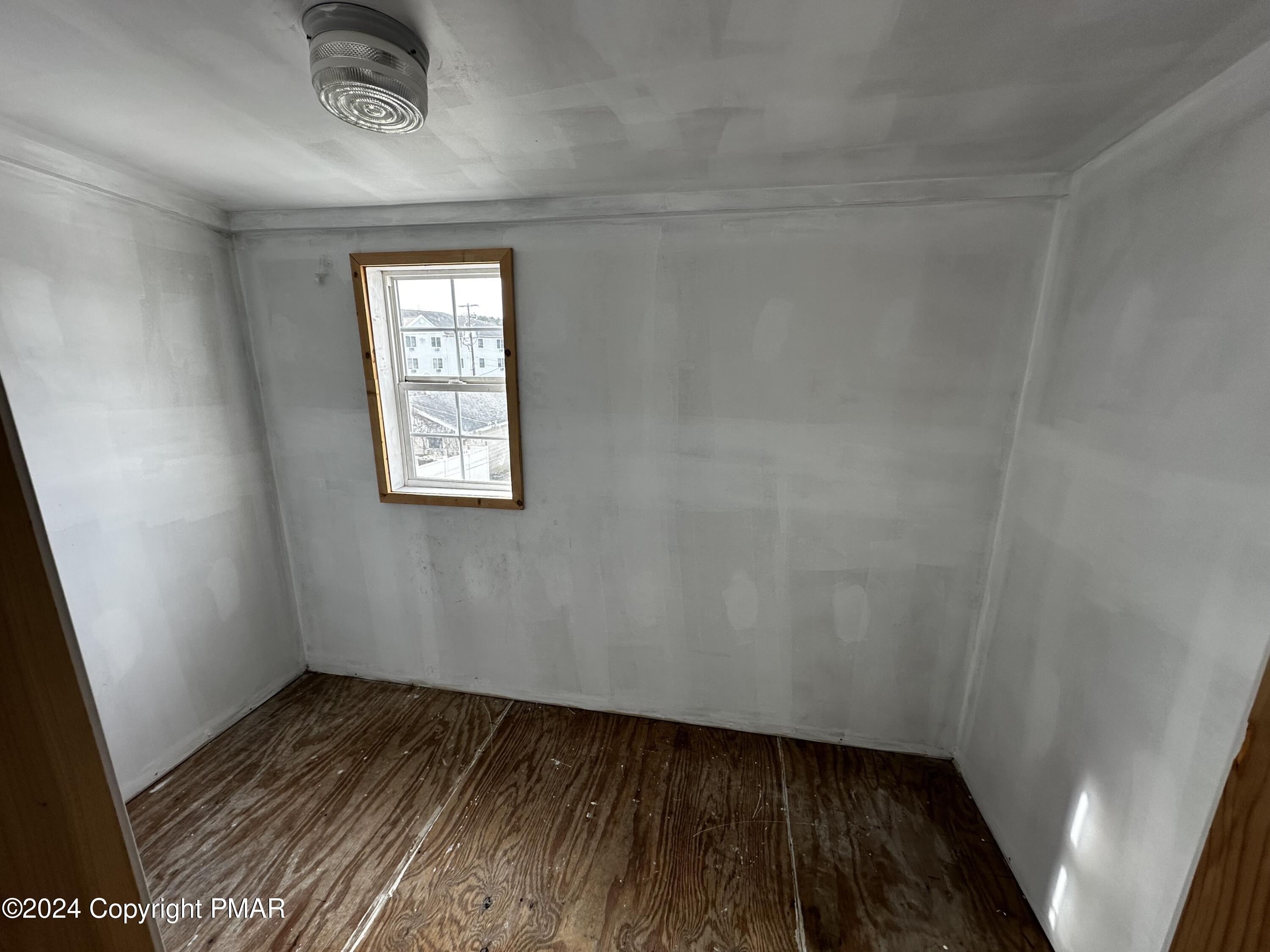 308 South Beech Street Mount Carmel, PA 17851 - Photo 27 of 34 an empty room with wooden floor and windows