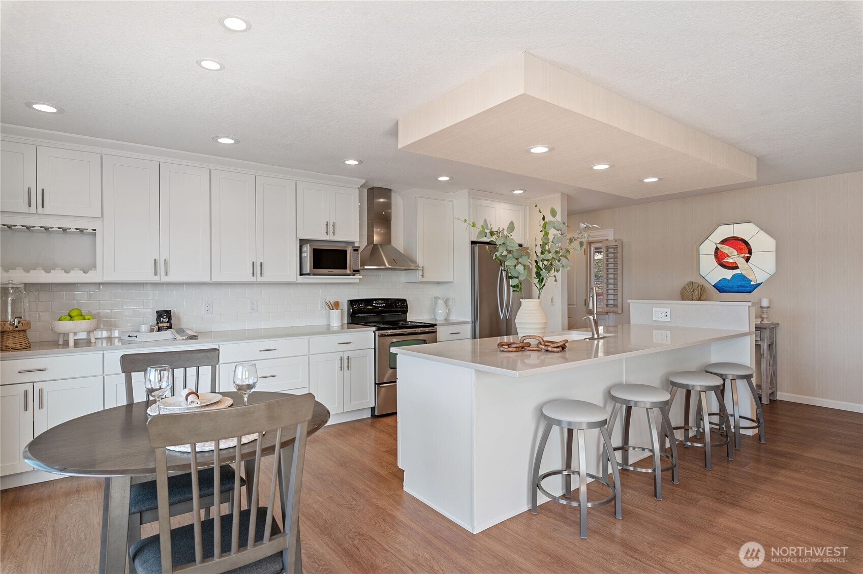 14191 Highway 106 Belfair, WA 98528 - Photo 13 of 40 a kitchen with stainless steel appliances granite countertop a dining table chairs stove refrigerator and cabinets