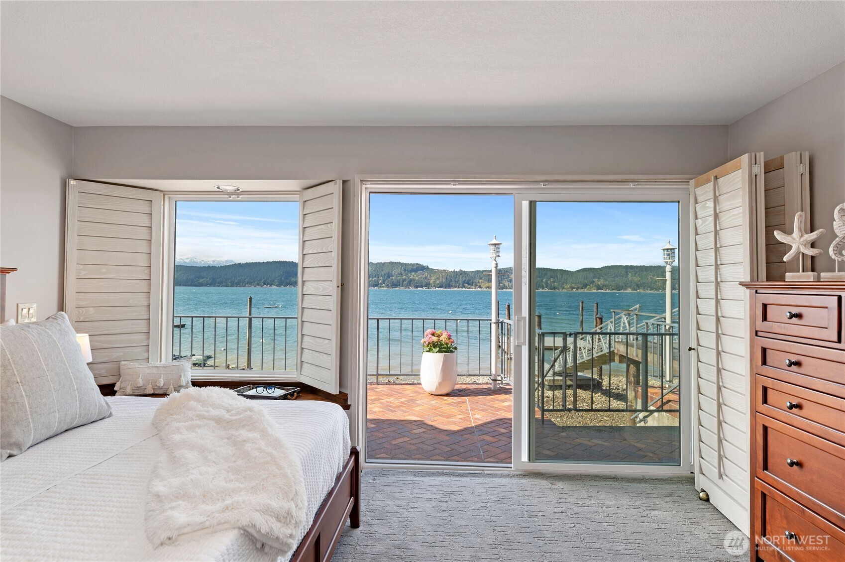 14191 Highway 106 Belfair, WA 98528 - Photo 21 of 40 a bedroom with a bed and large window