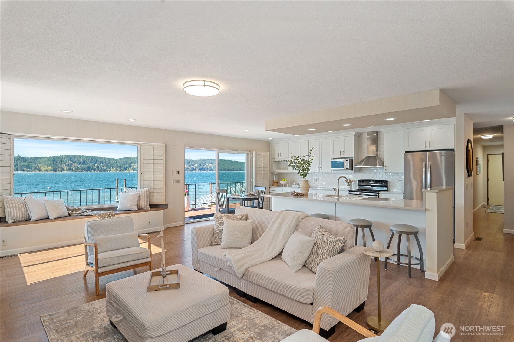 14191 Highway 106 Belfair, WA 98528 - Photo 5 of 40 a living room with furniture and a table with kitchen view