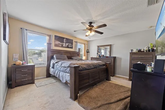 a bedroom with a bed dresser and a window