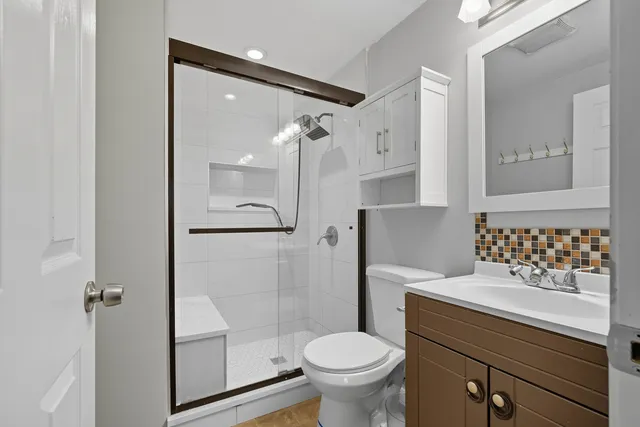 a bathroom with a sink toilet and shower