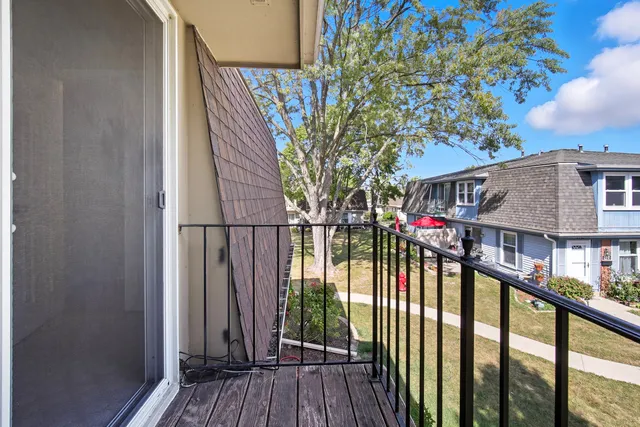 a view of balcony with small garden and wooden stairs