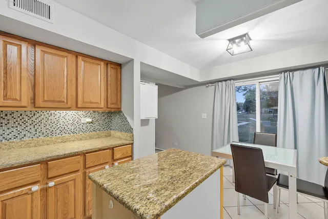 a kitchen with a table and chairs in it