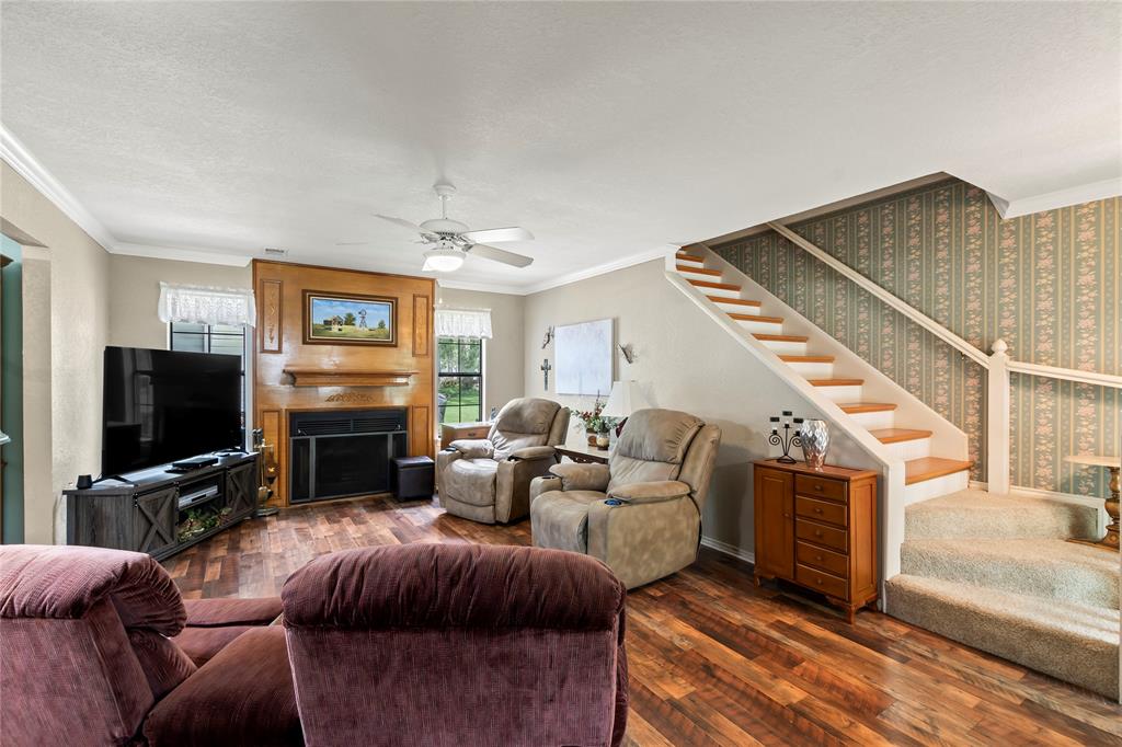 455 Stirrup Ranch Road Trinidad, TX 75163 - Photo 10 of 20 a living room with furniture a flat screen tv and a fireplace