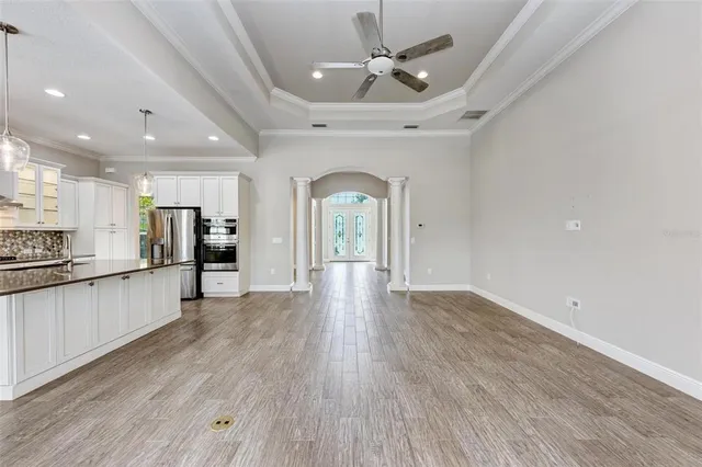 a kitchen with kitchen island white cabinets and stainless steel appliances