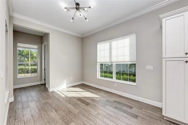 a view of wooden floor and windows in a room