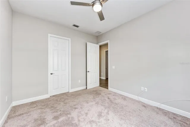 an empty room with a empty space and windows