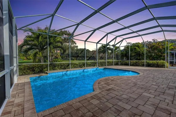 an aerial view of residential houses with outdoor space and lake view