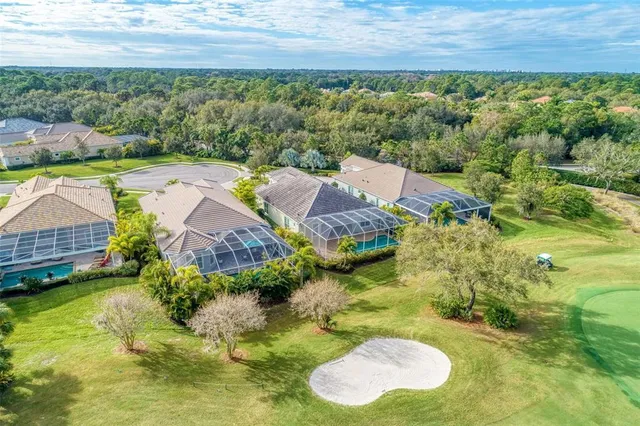 a front view of a house with a yard and potted plants