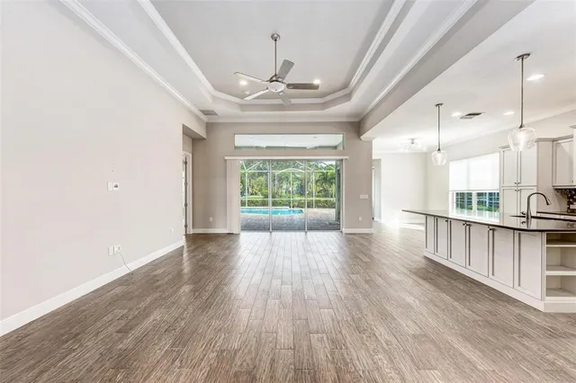 a large kitchen with stainless steel appliances granite countertop a lot of counter space and wooden floors