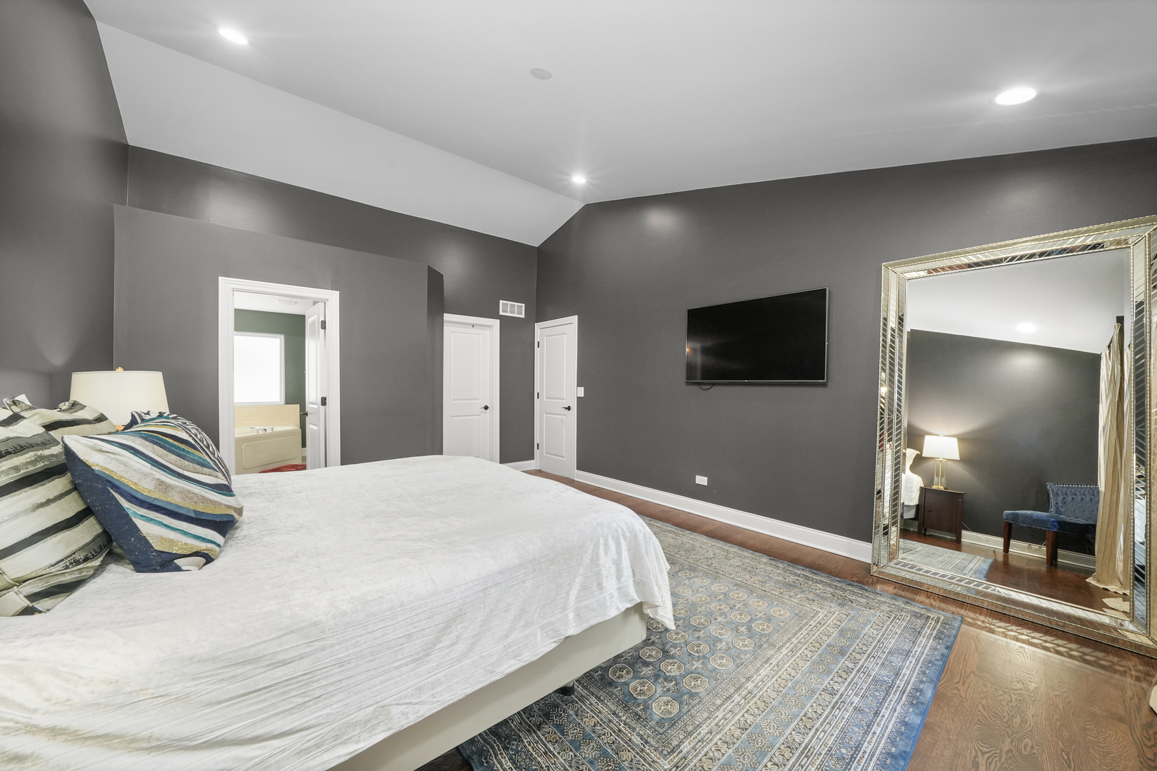 1916 Windstone Drive Plainfield, IL 60586 - Photo 28 of 50 a spacious bedroom with a bed and a flat screen tv