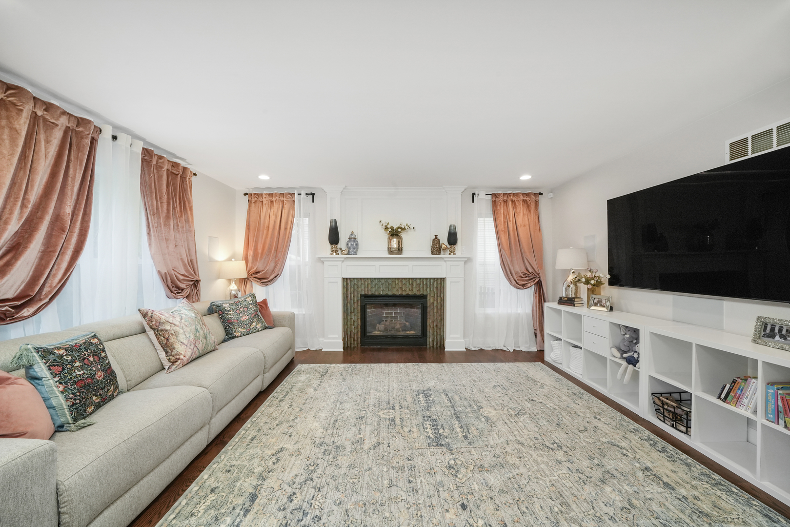 1916 Windstone Drive Plainfield, IL 60586 - Photo 3 of 50 a living room with furniture a flat screen tv and a fireplace