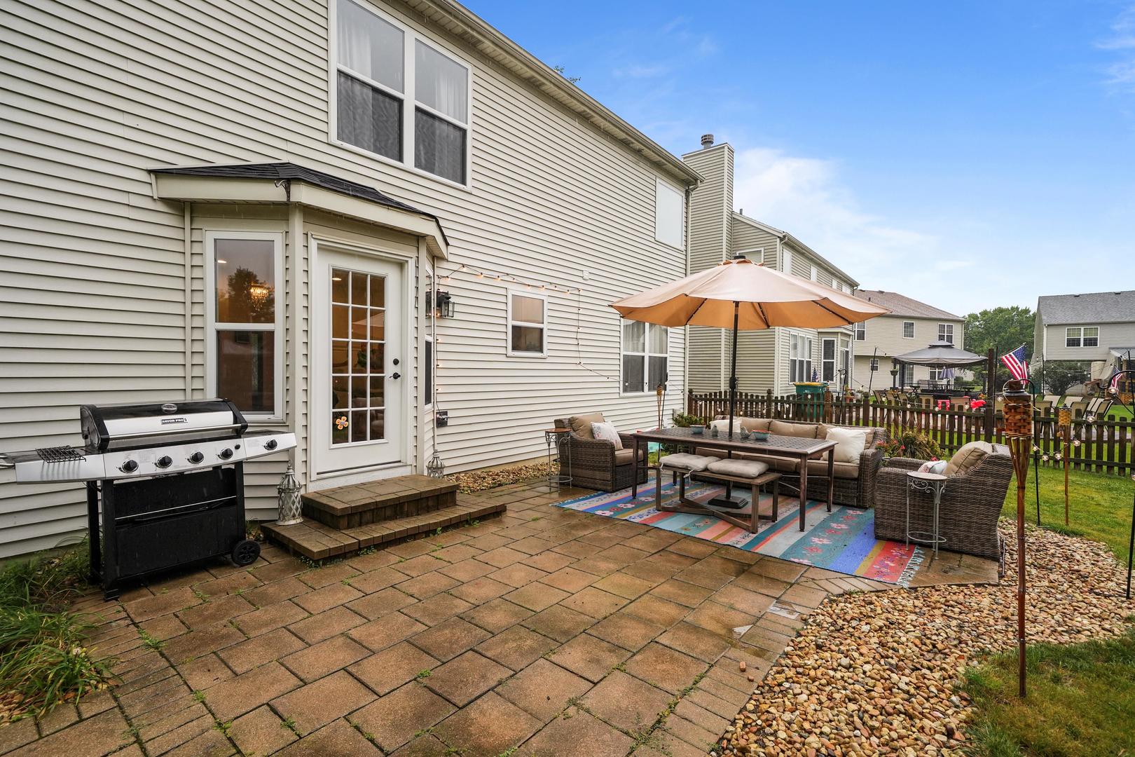 1916 Windstone Drive Plainfield, IL 60586 - Photo 46 of 50 a patio with patio table and chairs