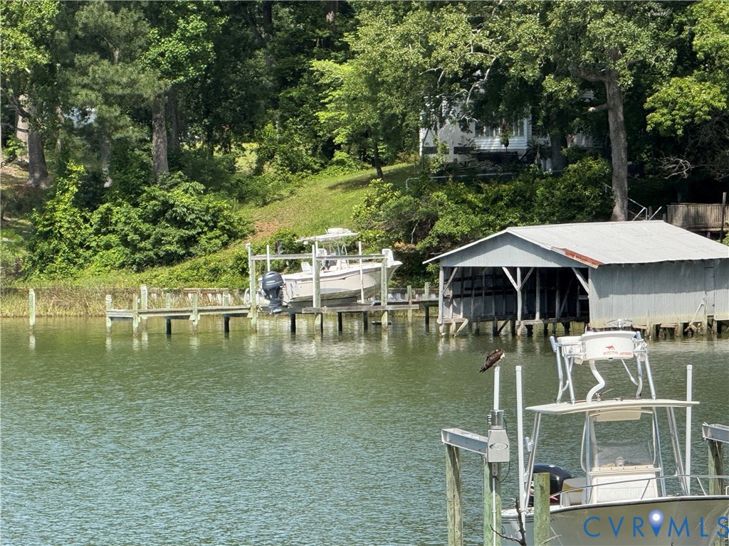 1686 Locust Grove Road Topping, VA 23169 - Photo 15 of 31 Dock area featuring boat lift and a water view