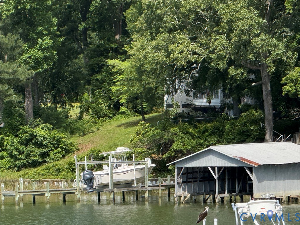 1686 Locust Grove Road Topping, VA 23169 - Photo 16 of 31 Dock area featuring boat lift and a water view