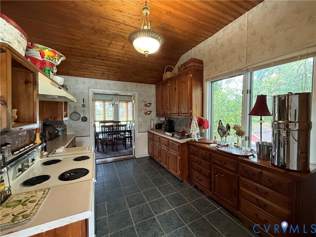 1686 Locust Grove Road Topping, VA 23169 - Photo 20 of 31 Kitchen with wooden vaulted ceiling, wood cabinets