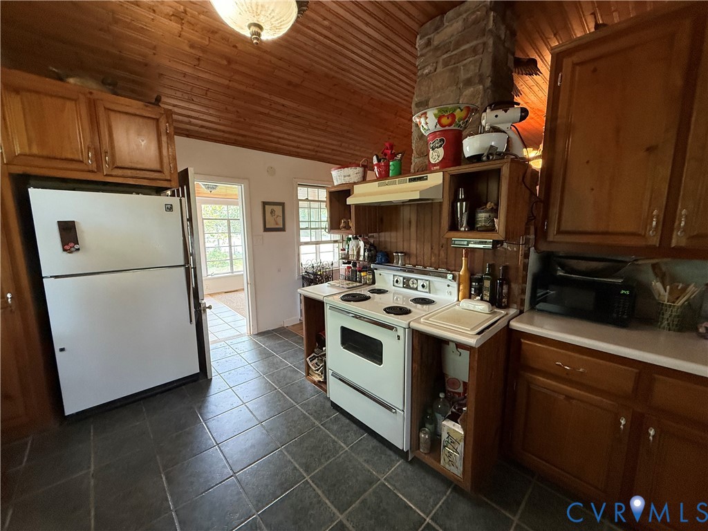 1686 Locust Grove Road Topping, VA 23169 - Photo 26 of 31 Kitchen featuring wooden cabinetry, white applianc