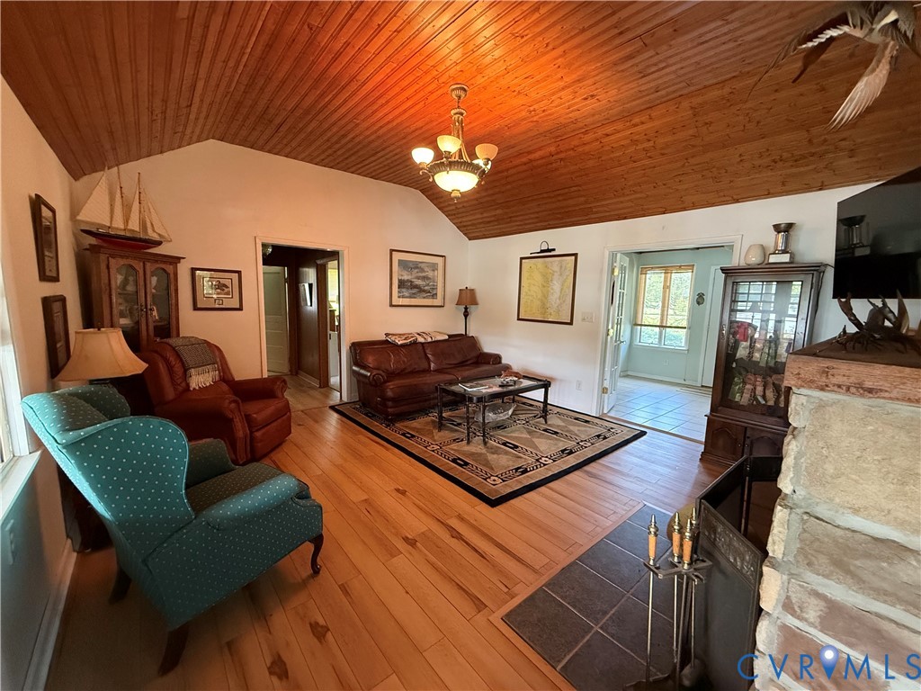 1686 Locust Grove Road Topping, VA 23169 - Photo 28 of 31 Living area featuring lofted ceiling, a chandelier