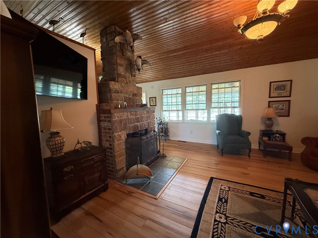 1686 Locust Grove Road Topping, VA 23169 - Photo 29 of 31 Living area with a fireplace and wood ceiling