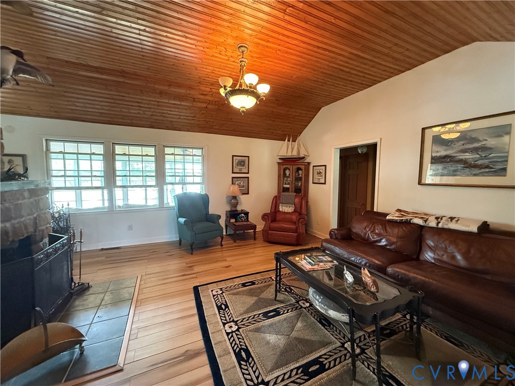 1686 Locust Grove Road Topping, VA 23169 - Photo 30 of 31 Living area with vaulted, wood ceiling, and a chan