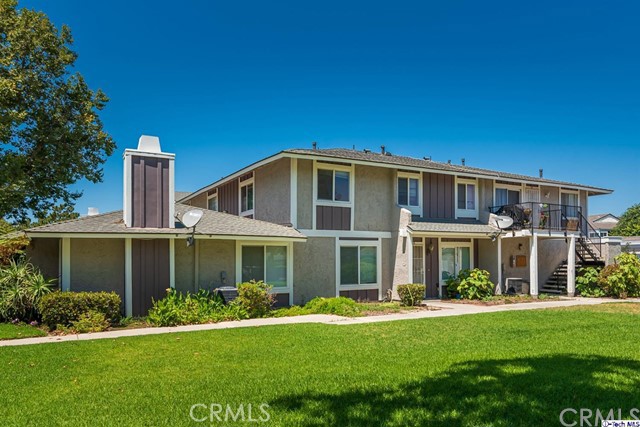 581 Spring Road, Unit 58 Moorpark, CA 93021 - Photo 1 of 1 a front view of a house with a yard table and chairs