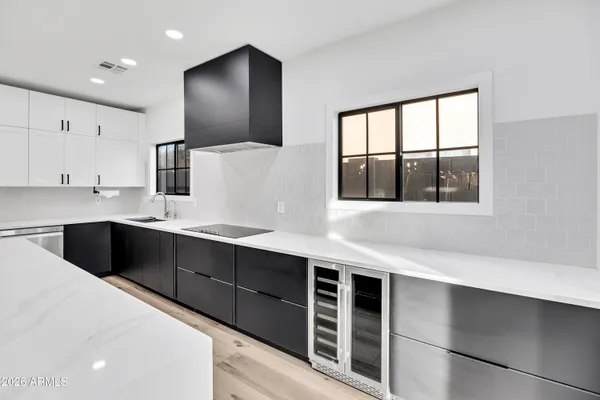 a kitchen with stainless steel appliances a sink and a large window