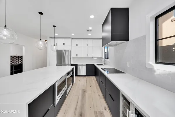 a large kitchen with a large counter top appliances and cabinets