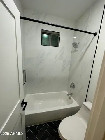 a bathroom with a toilet a sink and bathtub
