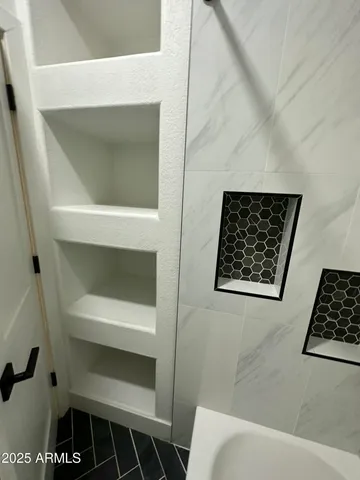 a bathroom with a toilet and a picture